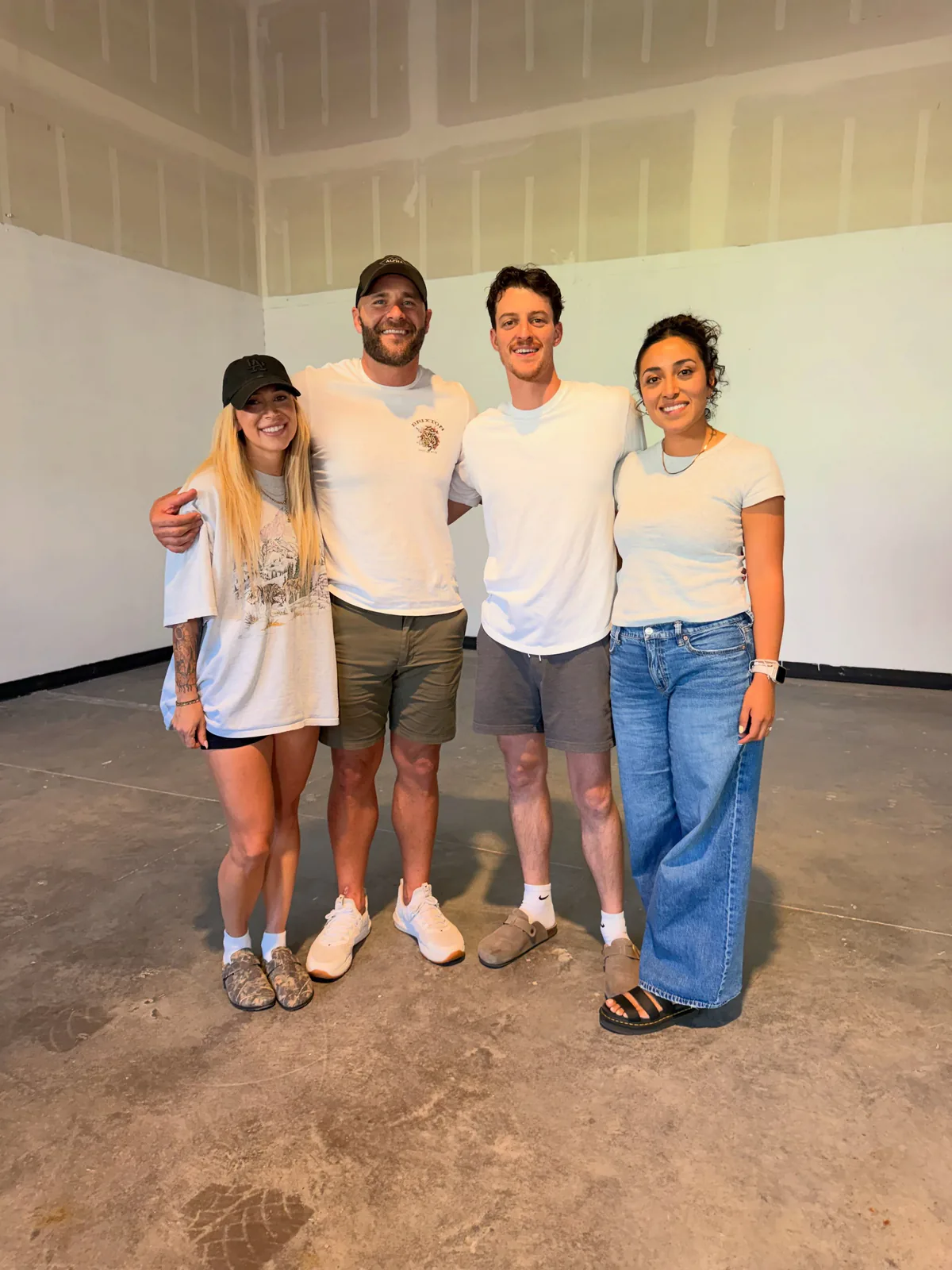 Four people standing together inside the Crossroads Combat Club gym during its buildout.
